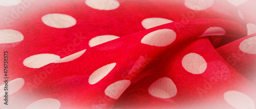 Background texture  decorative ornament  red polka dot fabric in white polka dots  round dots on fabric  shaped like or approximately like a circle or cylinder