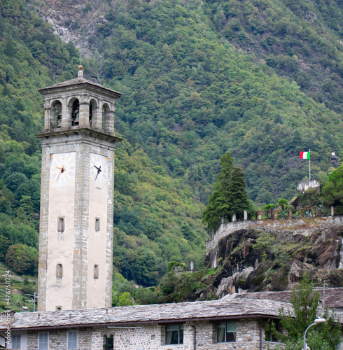 Church Bell Tower in Prosto Italy with Italian Flag – Small Italian village in the European Alps made popular by B&B accommodations photo