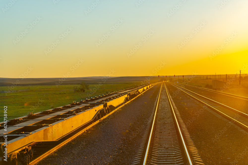 railway, railroad, rail, elevated. steppe prairie veld. is a means of transportation and passengers of trucks moving on rails that are located on the rails of the Great Plains. Kazakhstan t.
