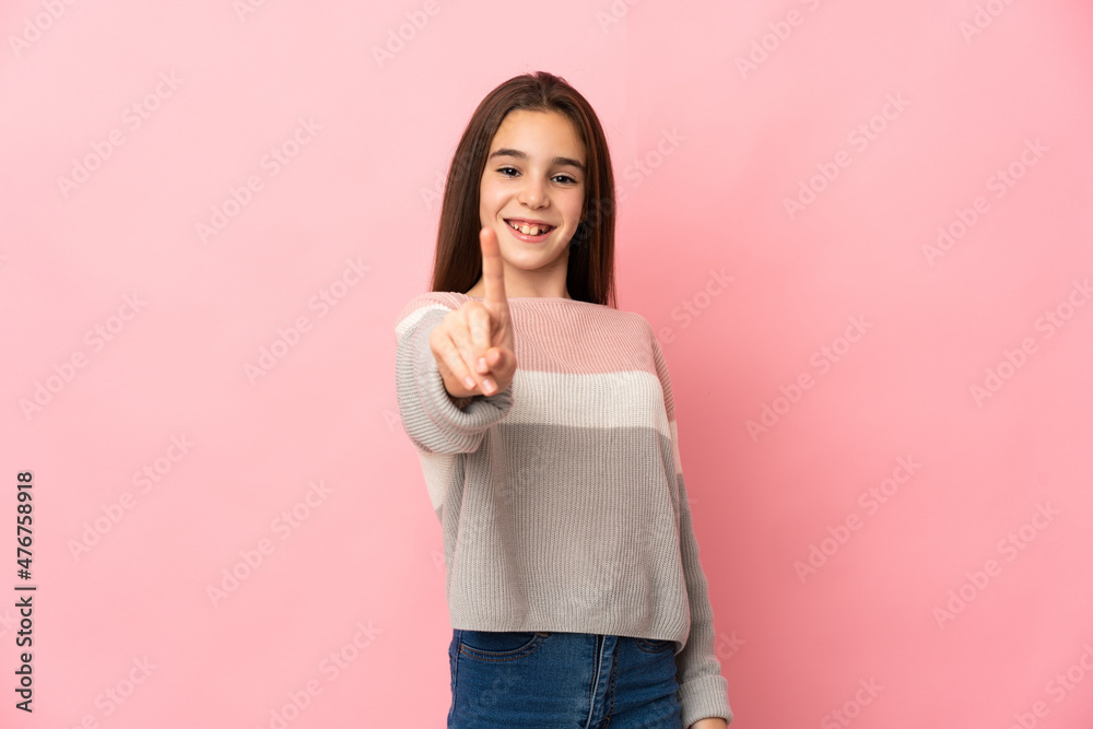Little girl isolated on pink background showing and lifting a finger Little girl isolated on pink background showing and lifting a finger