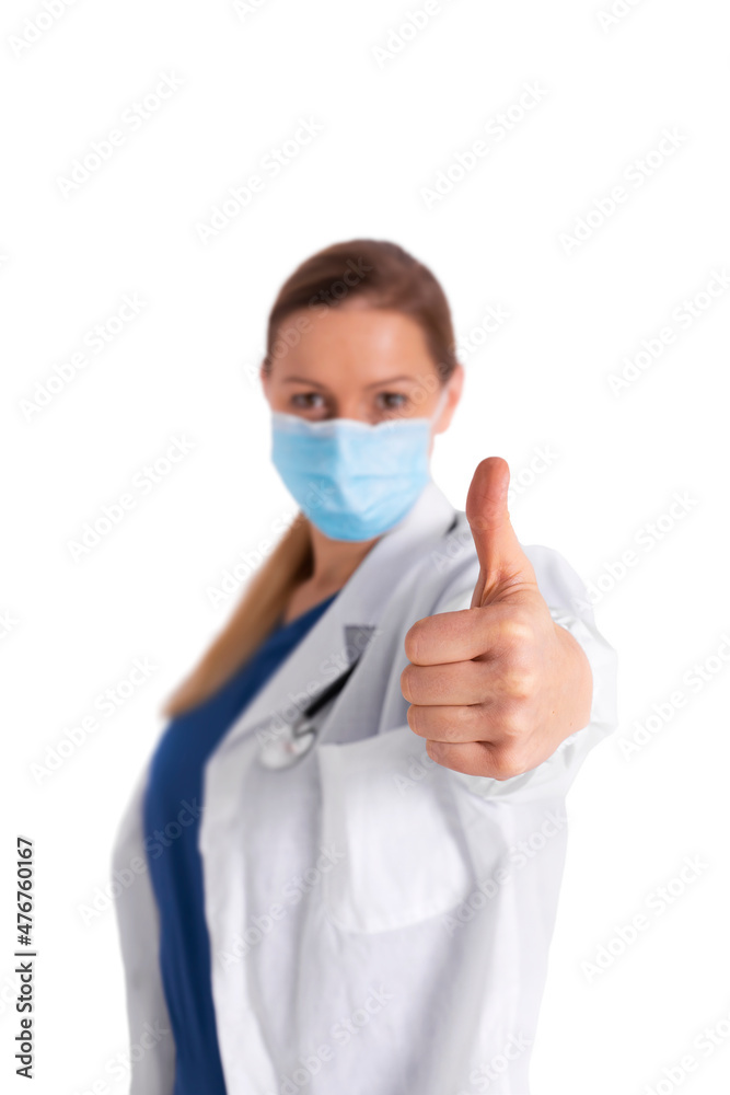 Portrait of young female doctor in medical mask looking at camera and showing thumb-up, isolated on white background. Satisfied doctor with white coat good results on studying virus, discover vaccine Portrait of young female doctor in medical mask looking at camera and showing thumb-up, isolated on white background. Satisfied doctor with white coat good results on studying virus, discover vaccine
