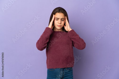 Little girl isolated on purple background with headache © luismolinero