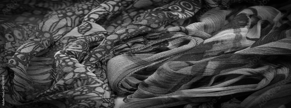 Background texture, Black and white silk fabric, silver. titanium. floral pattern, corrugation, reef, undulation, undulation, ripples, a small wave or a series of waves on the surface of the fabric
