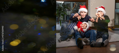 joyful child boys in Santa hats in positive pre - holiday mood playing with festive balls lights garland decoration and waiting holidays and New Year