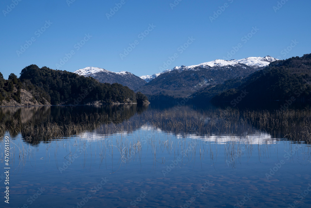 Beauty in nature. View of volcano Batea Mahuida, Andes mountains, forest and Alumine lake in Villa Pehuenia, Patagonia Argentina. Beautiful landscape and blue sky reflection in the glacier water.