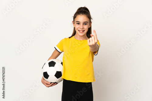 Little football player girl isolated on white background doing coming gesture © luismolinero