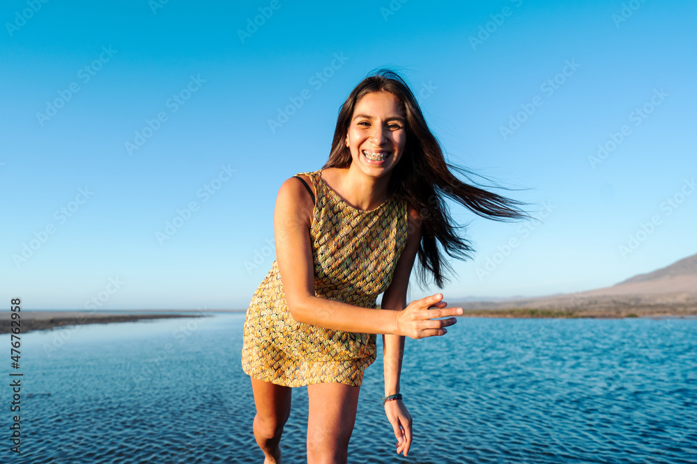 Φωτογραφία young latin woman smiling with dental braces happy looking at the camera, wide a