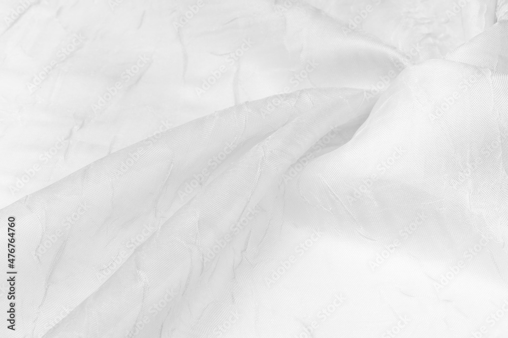 Silk fabric White. Dented and smoothed with traces of stripes. Texture background. Matte wedding satin fabric. These sophisticated lightweight stretch satin textiles create a stylish look.