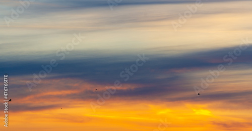 Beautiful morning sky. Orange red blue paints. Heavenly abstract summer gentle background. Beautiful picturesque bright majestic dramatic evening morning sky at sunset or dawn.