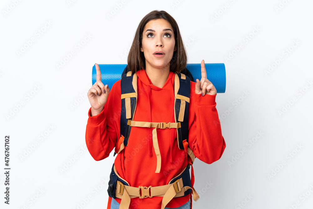 Young caucasian mountaineer girl with a big backpack isolated on white background pointing with the index finger a great idea Young caucasian mountaineer girl with a big backpack isolated on white background pointing with the index finger a great idea