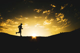 Silhouette of a man running freely in the mountains.