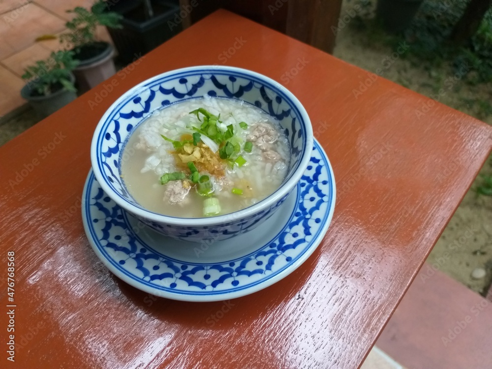 rice soup on wooden table rice soup on wooden table