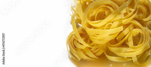 Pappardelle are large, very broad, flat pasta, similar to wide fettuccine, originating from the region of Tuscany. The fresh types are two to three centimetres wide and may have fluted edges