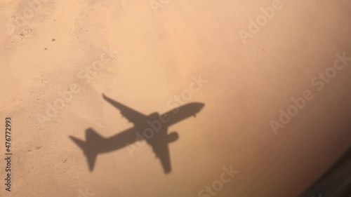 shadow of the plane on the sand that comes in for landing is approaching