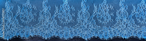 Blue lace on a black background. Template for wedding invitation and greeting card with lace fabric background.