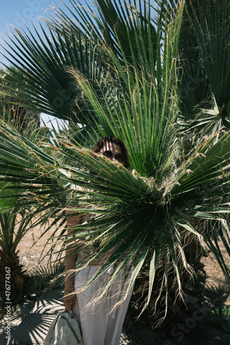 girl near a palm tree in summer in Turkey