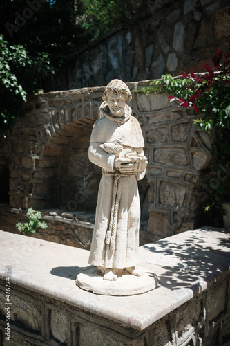 small statue of a monk on the street in Turkey in summer