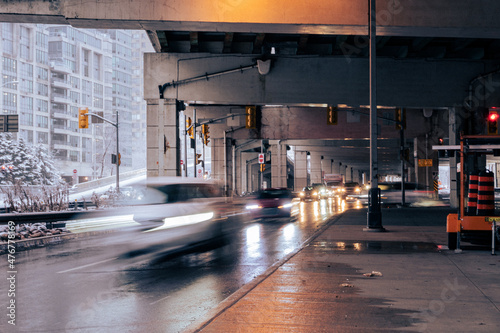 Traffic moves briskly along Lakeshore Boulevard under the Gardiner Expressway through downtown Toronto. photo