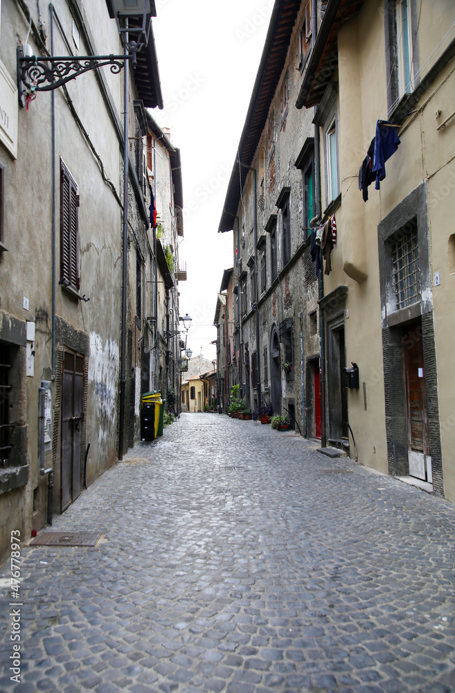 The perspective of a paved street of the village with typical buildings, Bracciano, Lazio, Italy