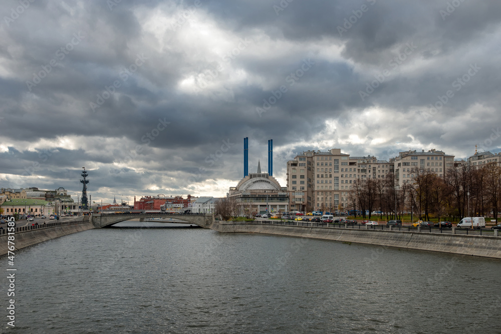 The house on the embankment, the Drainage canal, the Small Stone Bridge, the Udarnik cinema and the blue pipes of HPP-2. Urban autumn landscape The house on the embankment, the Drainage canal, the Small Stone Bridge, the Udarnik cinema and the blue pipes of HPP-2. Urban autumn landscape