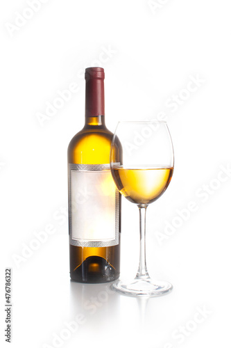 A bottle of wine and a full glass of white wine. 
On a white background