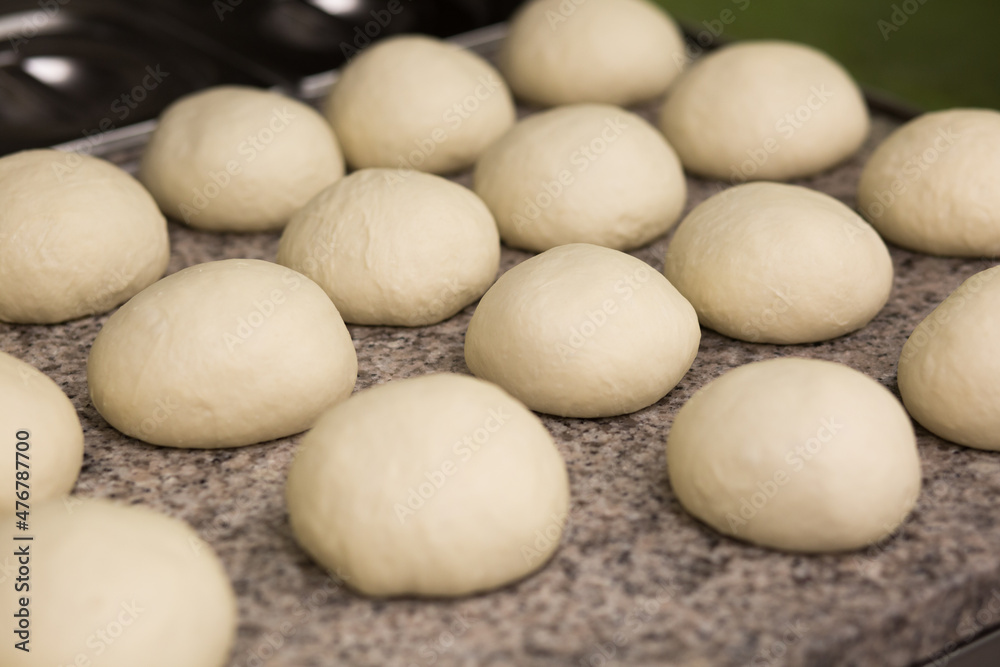 Dough. Fresh raw dough preparation. Preparing pizza dough on a professional culinary worktop. Pizzeria Dough. Fresh raw dough preparation. Preparing pizza dough on a professional culinary worktop. Pizzeria