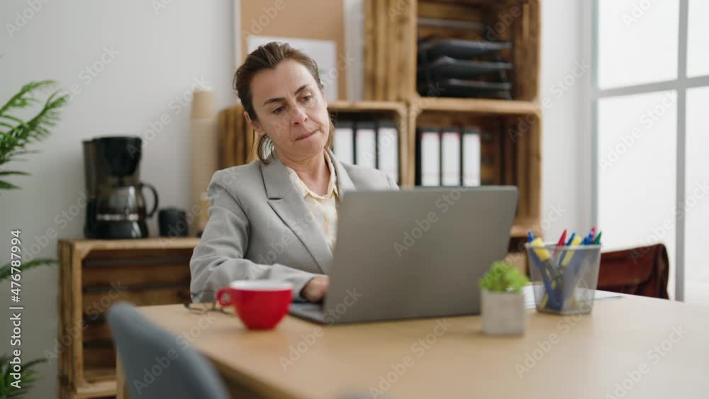 Middle age woman business worker with winner expression using laptop at office Middle age woman business worker with winner expression using laptop at office