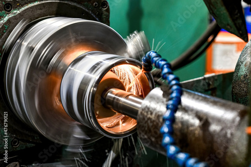 Small sparks are emitted during the internal grinding of a cylindrical part.