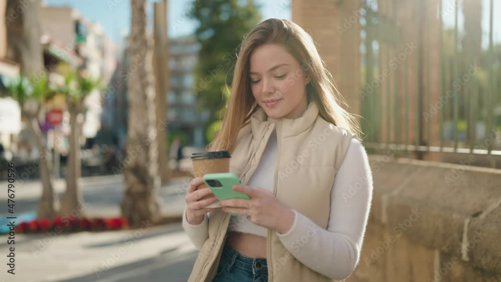 Young blonde woman using smartphone drinking coffee at street Young blonde woman using smartphone drinking coffee at street