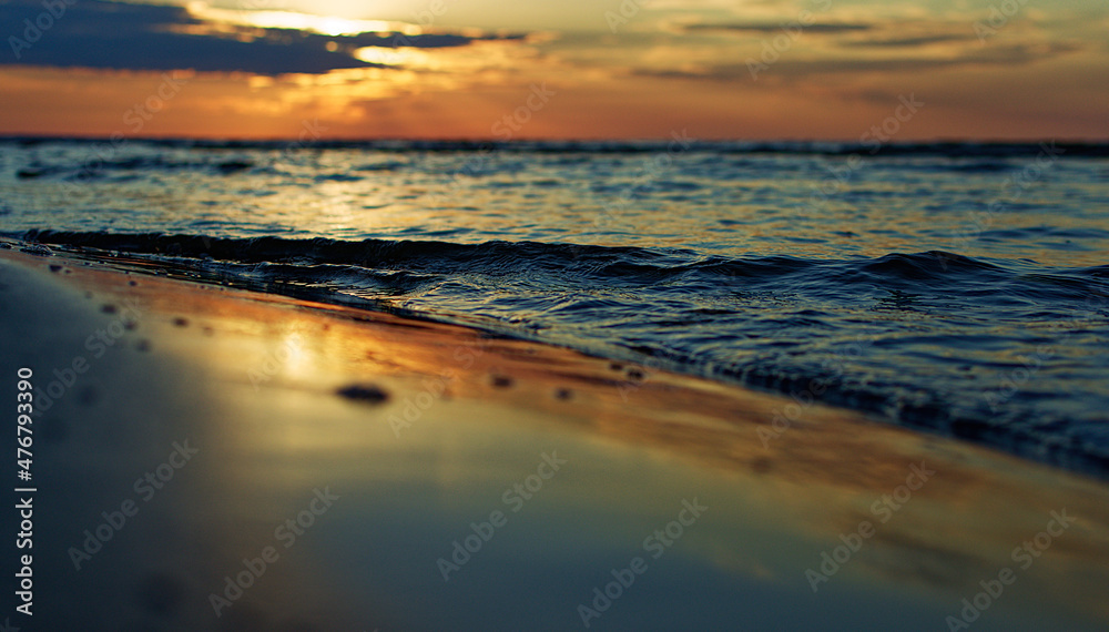Warm summer sunset on the Baltic Sea in the Gulf of Riga in Jurmala. Shallow depth of field.