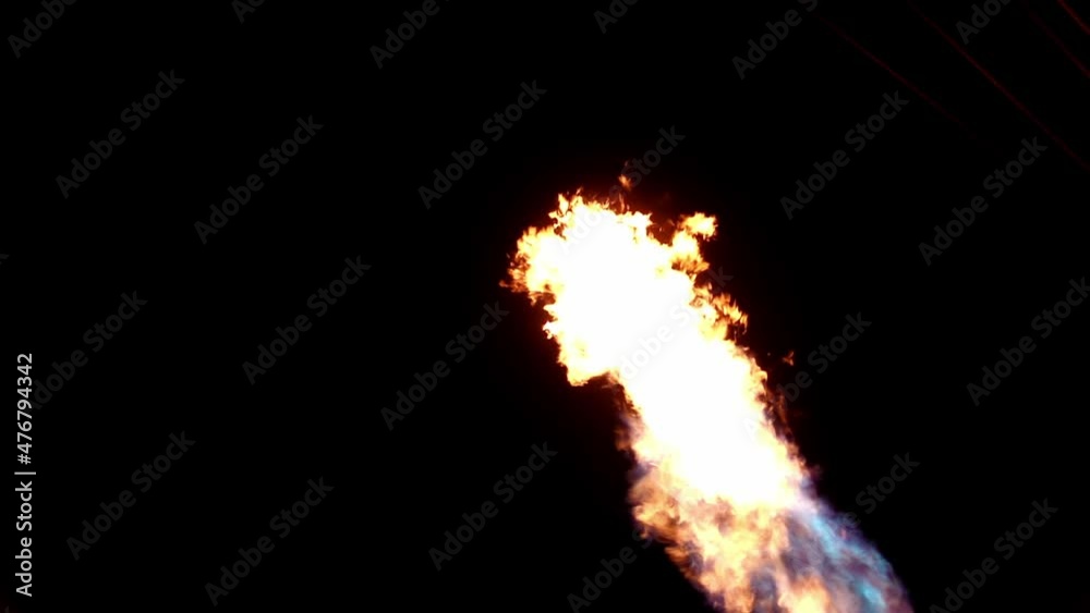 Stream of fire burning in the darkness inside of hot air balloon filmed in slow motion from above. Blazing flame is sparkling at night time. Aerostat is filled with hot temperature gas. Power of fuel. Stream of fire burning in the darkness inside of hot air balloon filmed in slow motion from above. Blazing flame is sparkling at night time. Aerostat is filled with hot temperature gas. Power of fuel.