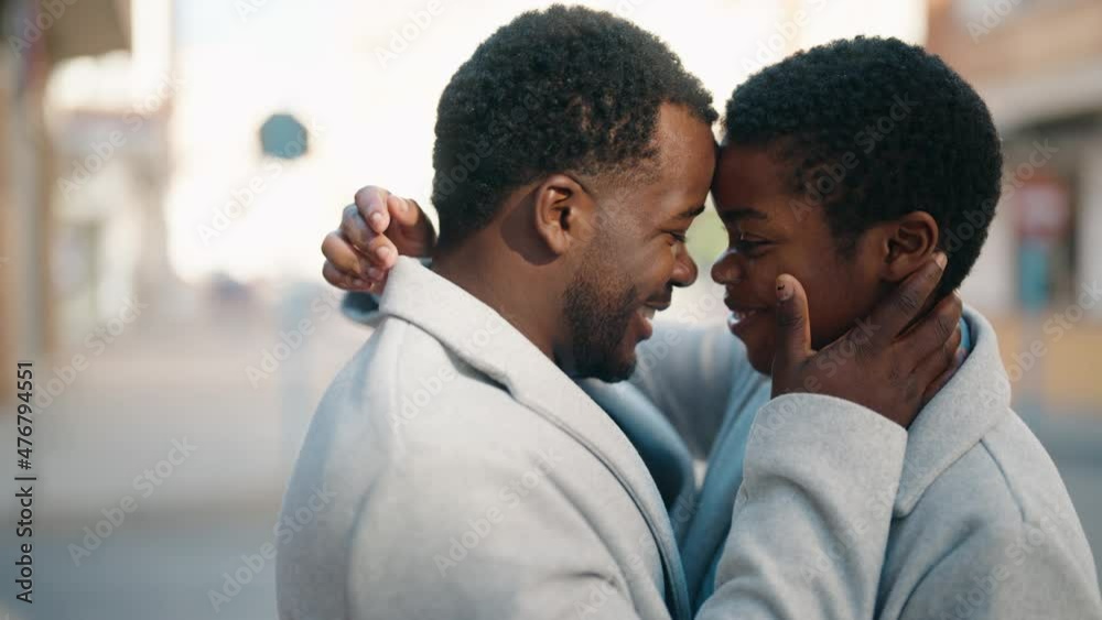 African american couple kissing and hugging each other at street African american couple kissing and hugging each other at street