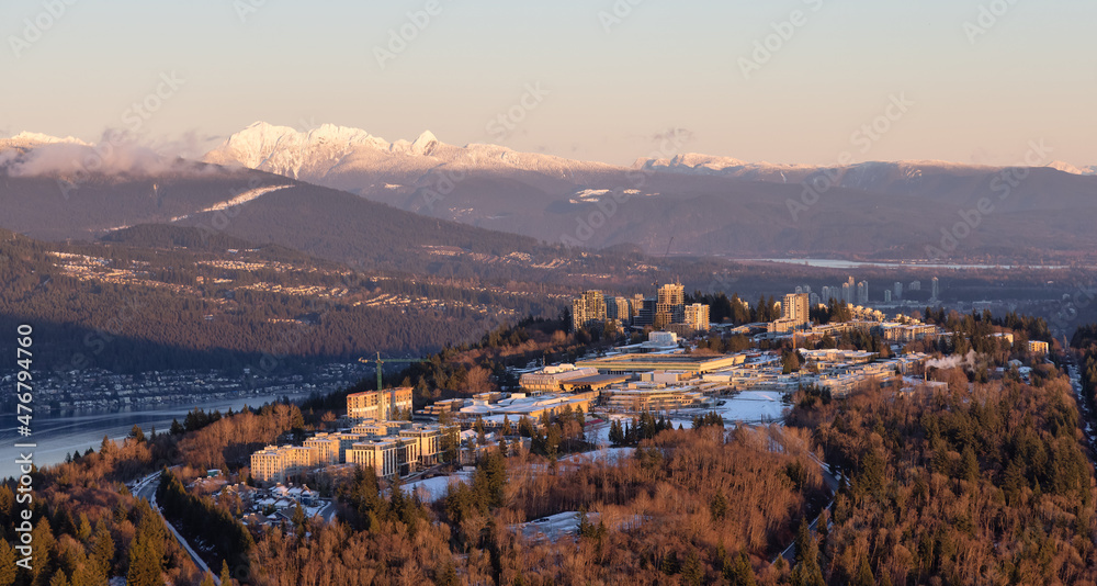 Aerial view of Simon Fraser University, SFU, on Burnaby Mountain. Picture taken from an Airplane in Vancouver Lower Mainland, British Columbia, Canada. Sunny Winter Sunset