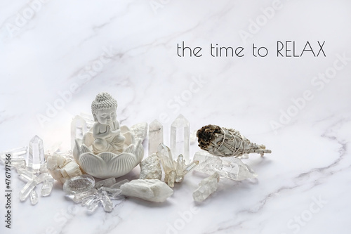 the time to relax - motivation inspiration quote. quartz minerals, Buddha statue on marble background. gemstones crystals for healing esoteric spiritual practice, relaxation, meditation. life balance