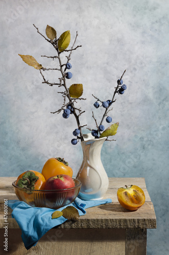 Wonderful still life with persimmons, vase and berries. Good illustration for book, journal or postcard.