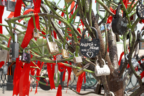 Close-up of colorful wedding locks on a metal tree on Luzhkov bridge in Moscow.
