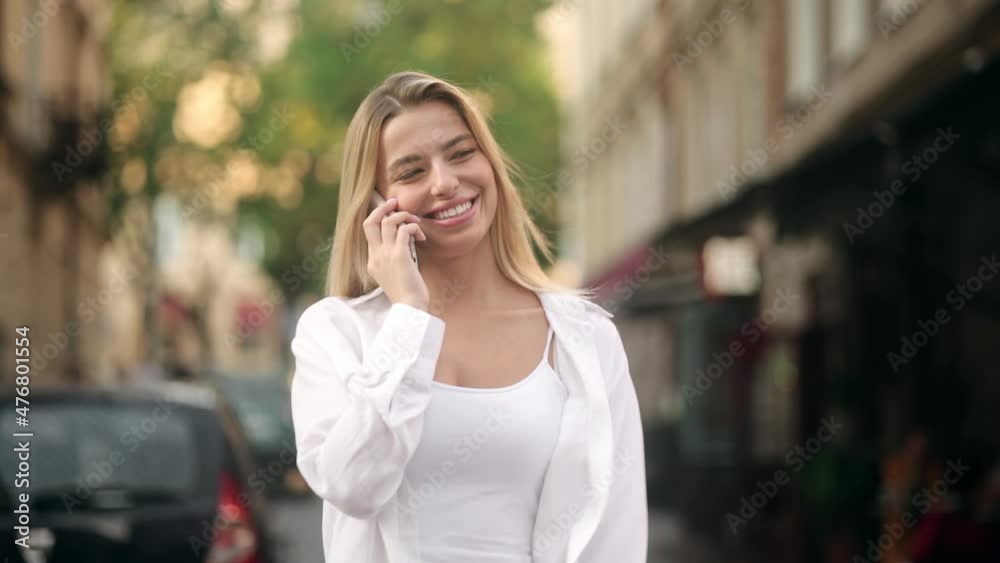 Happy blessed woman with blonde hair talking on mobile phone and laughing, expressing positive emotions, or a young joyful girl is having a pleasant conversation Happy blessed woman with blonde hair talking on mobile phone and laughing, expressing positive emotions, or a young joyful girl is having a pleasant conversation
