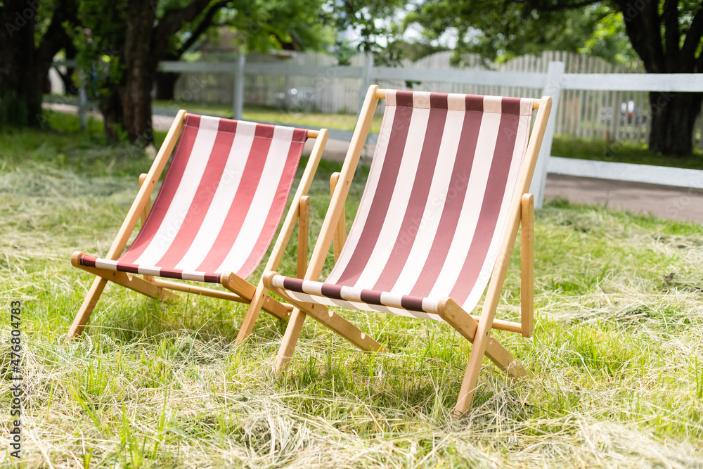 fabric sun lounger on green grass fabric sun lounger on green grass