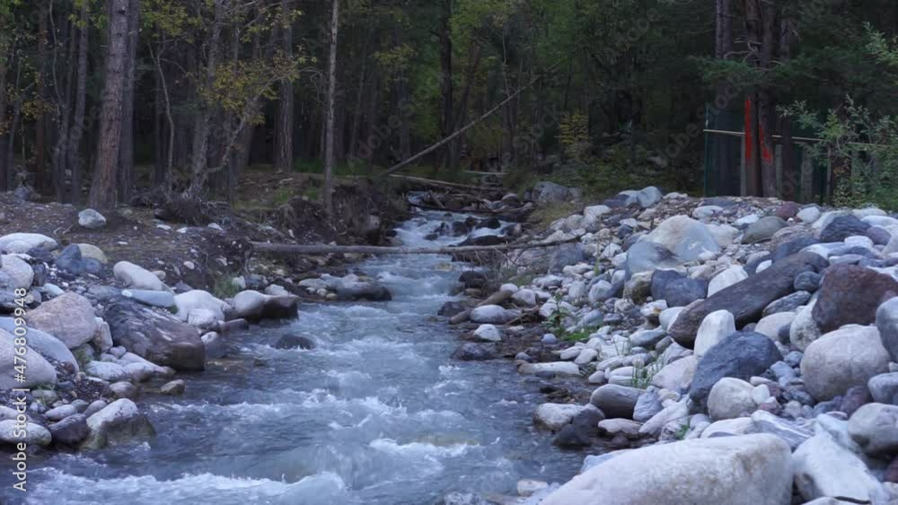 Mountain river flowing between rocky shores in Terskol, Russia. Mountain river flowing between rocky shores in Terskol, Russia.