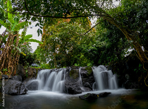 Long exposure view of a waterfall hidden in a forest located in the north of Mauritius island