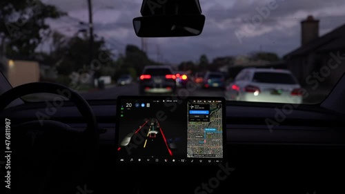 Interior view of fully autonomous electric car or EV in full self driving autopilot mode on city streets. photo