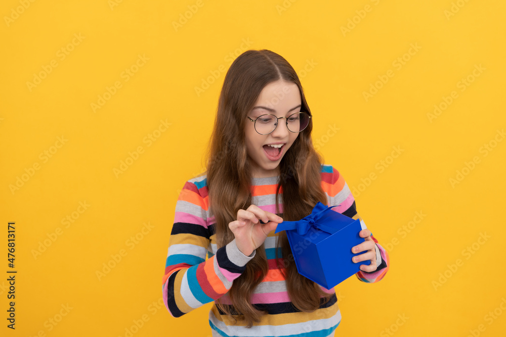 surprised teen girl in eyeglasses open box. boxing day. present and gifts buy surprised teen girl in eyeglasses open box. boxing day. present and gifts buy
