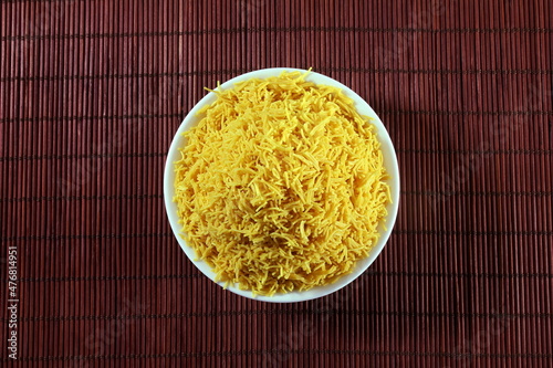 heap of sev noodles or vermicelli indian gujrati food snack in bowl, top view photo