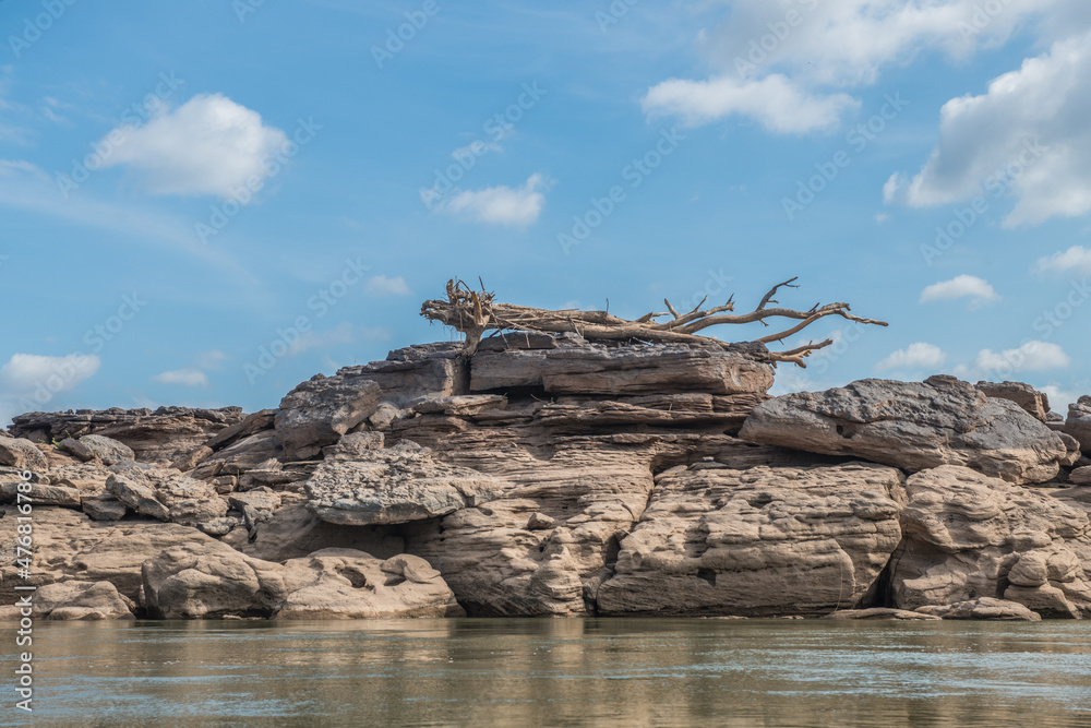 view from the boat: Rocks on both sides of the Mekong River