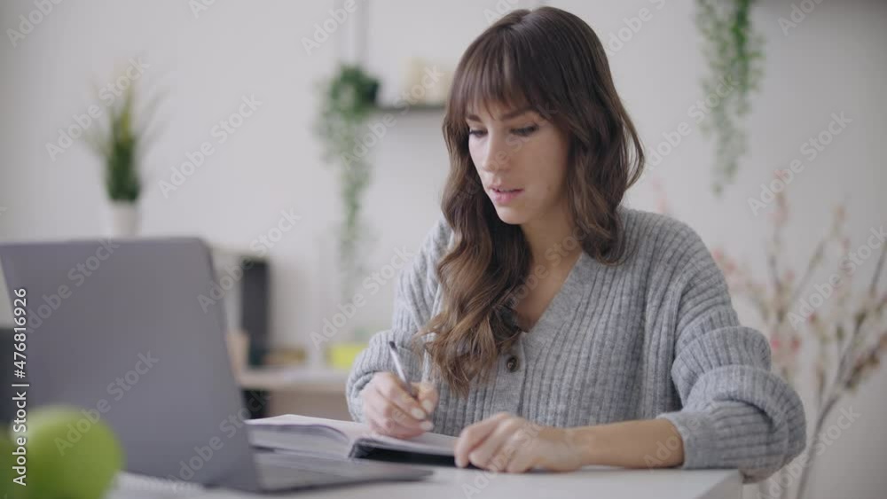 Smart young female with vitiligo studying at online school, working at laptop Smart young female with vitiligo studying at online school, working at laptop