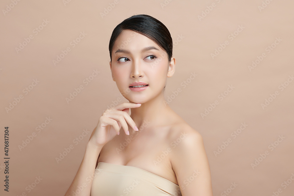 Beautiful young asian woman with clean fresh skin on beige background, Face care, Facial treatment, Cosmetology, beauty and spa, Asian women portrait. Beautiful young asian woman with clean fresh skin on beige background, Face care, Facial treatment, Cosmetology, beauty and spa, Asian women portrait.