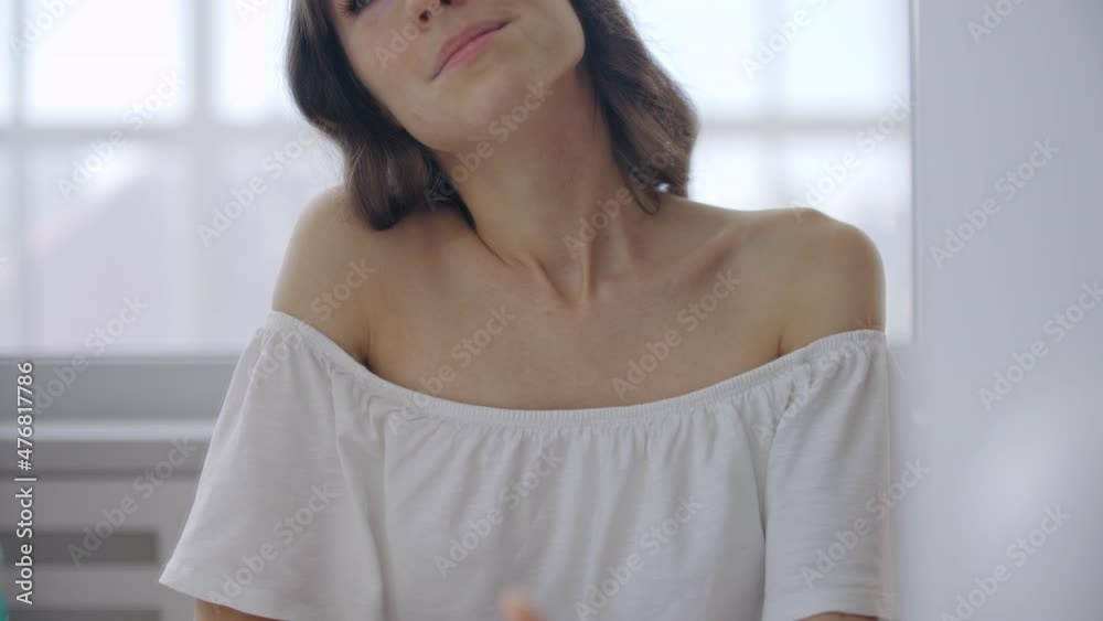 Happy young woman spraying favorite perfume on neck, preparing for romantic date Happy young woman spraying favorite perfume on neck, preparing for romantic date