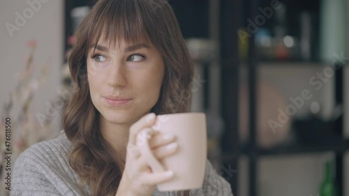 Casual young woman with skin depigmentation enjoying morning coffee at home photo