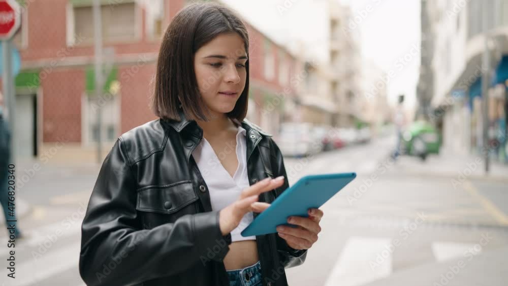 Young hispanic woman smiling confident using touchpad at street Young hispanic woman smiling confident using touchpad at street