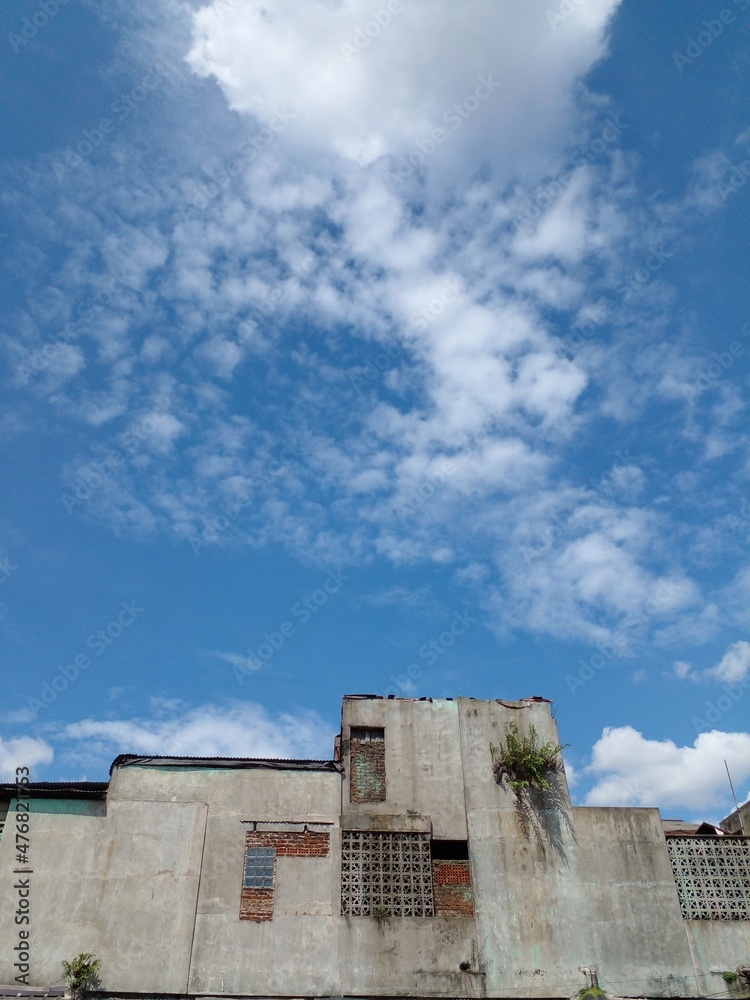 An Old Building and Blue Sky. Low angle view. Vertical